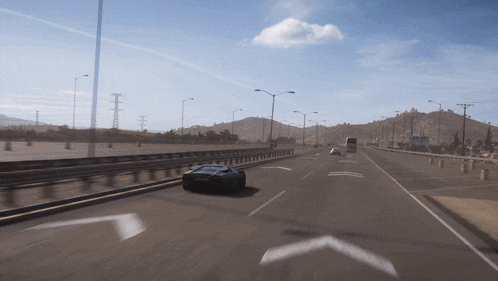 a car is driving down a highway with an arrow pointing right