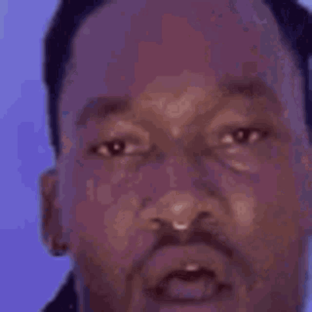 a close up of a man 's face with a surprised expression on his face .