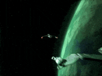 two spaceships are flying over a green planet in space