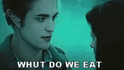 a man and a woman are looking at each other and the words `` what do we eat '' are written on the screen .