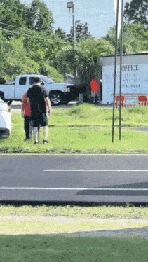 people standing on the side of the road in front of a sign that says office free storage