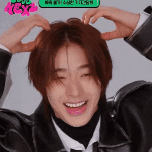 a man making a heart with his hands on his head