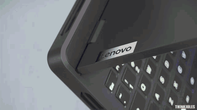 a black lenovo laptop is sitting on a white surface