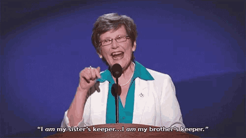a woman is speaking into a microphone and saying " i am my sister 's keeper ... i am my brother 's