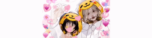 a couple of people are standing next to each other with a pumpkin hat on their head .
