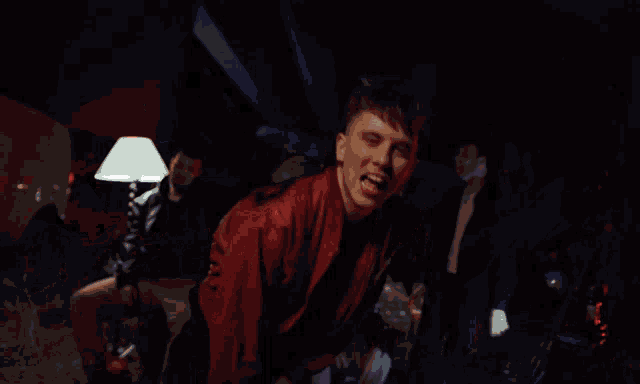 a blurry picture of a man in a red jacket dancing