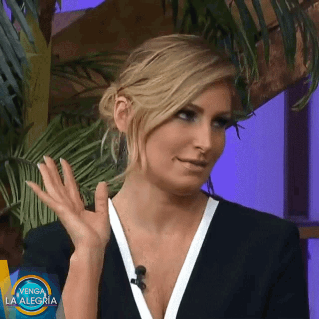a woman in a black and white dress is on a venga la alegria show