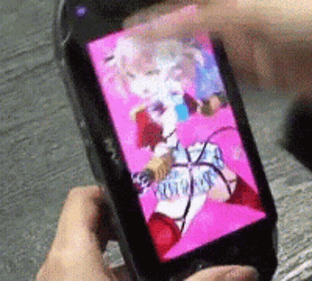 a person is holding a phone with a picture of a girl on the screen