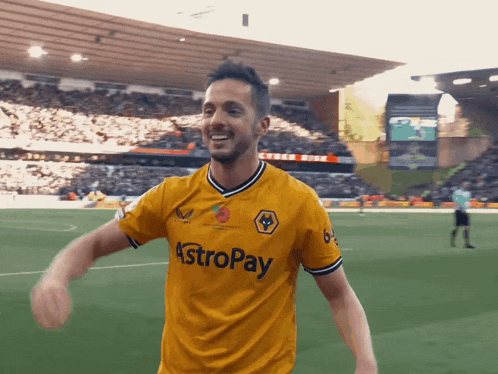 a soccer player wearing a yellow astropay shirt