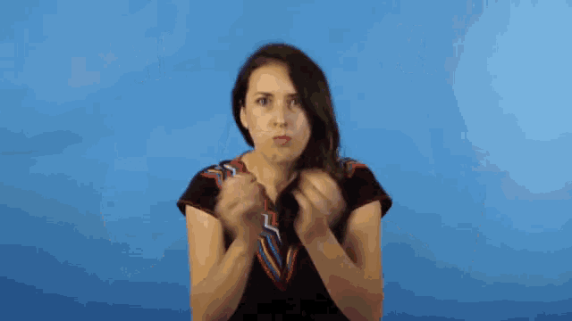 a woman with a surprised look on her face holds her hands up in the air and says nd blo