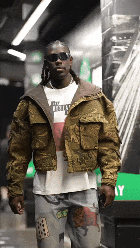 a man wearing sunglasses and a t-shirt that says " the rest "