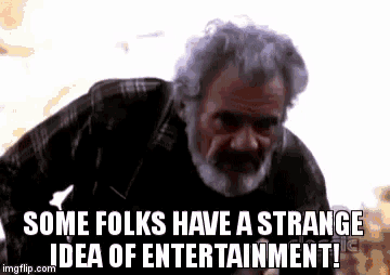 a man with gray hair and a beard is talking about a strange idea of entertainment .