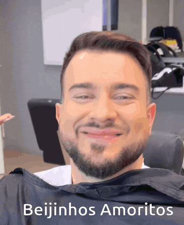 a man with a beard is smiling with the words beijinhos amoritos written below him