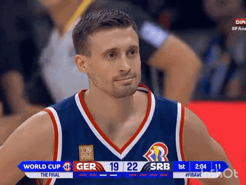 a man in a basketball uniform looks at the scoreboard during a world cup game