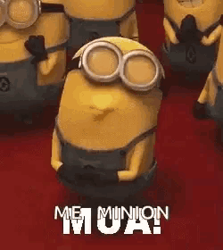 a group of minions are dancing on a red carpet .
