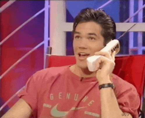 a man wearing a red shirt that says genuine on it