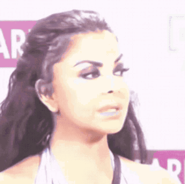 a close up of a woman 's face with a surprised look on her face .
