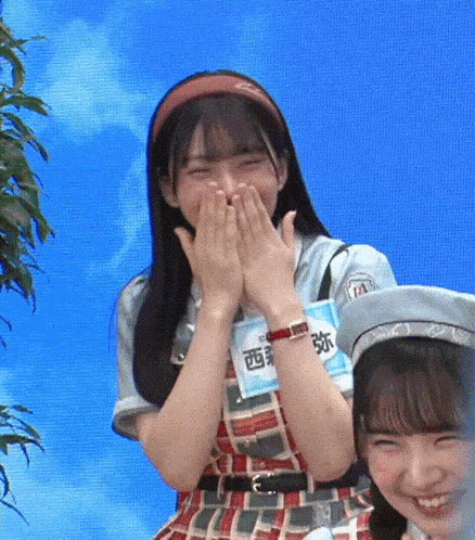 a girl with a name tag that says ' a ' on it is laughing .