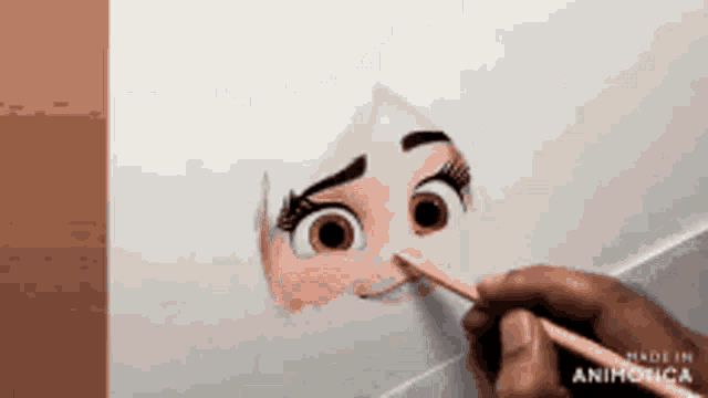 a person is drawing a girl 's face with a pencil on a piece of paper .