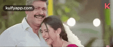 a man and a woman are laughing together while standing next to each other .