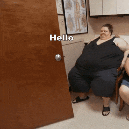 a woman sitting in front of a door with the word hello on it