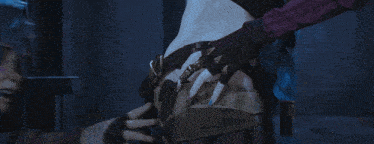 a woman with blue hair kisses another woman on the cheek