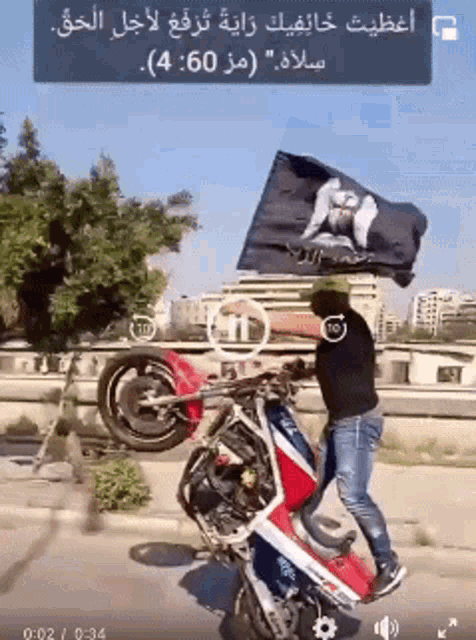 a man is riding a motorcycle with a flag on his head
