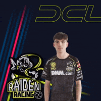 a man wearing a raid racing shirt is giving the peace sign