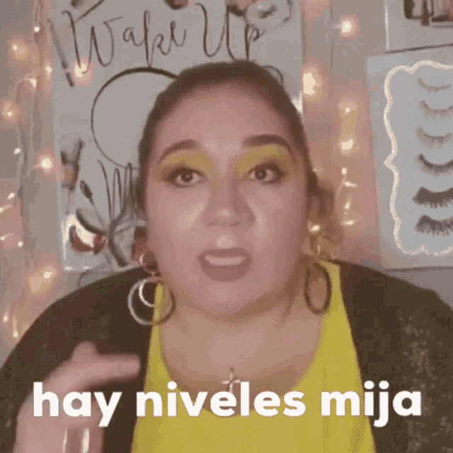 a woman says hay niveles mija in front of a poster that says wake up