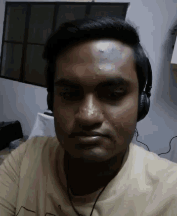 a man wearing headphones looks at the camera