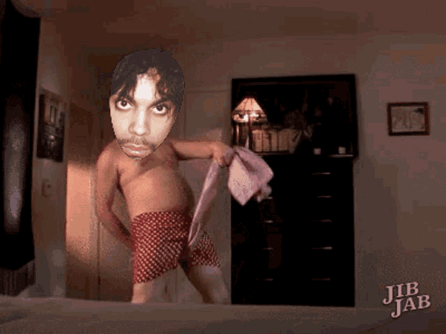 a man without a shirt is holding a pink towel in a bedroom with jib jab written on the bottom