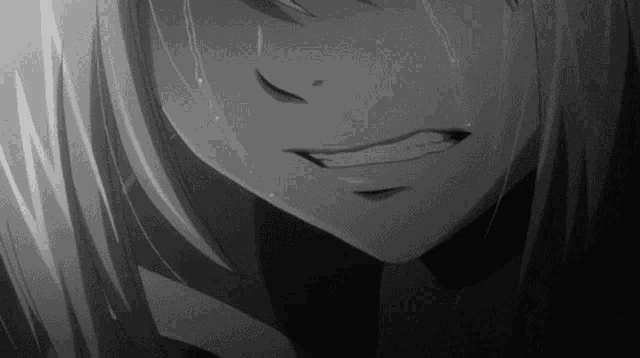 a black and white photo of a girl crying with tears coming down her face .