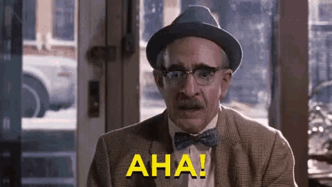 a man in a hat and bow tie says aha !