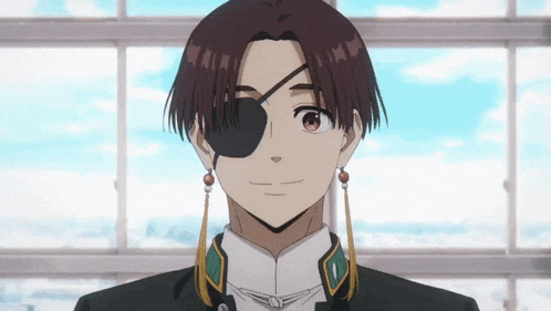 a young man with a bandage on his eye is smiling .