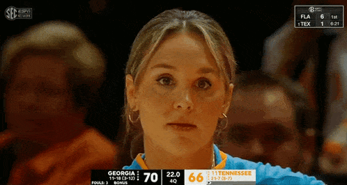 a woman watches a game between georgia and tennessee on espn