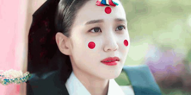 a woman with red circles on her face