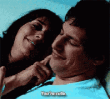 a woman is petting a man while he says you 're cute