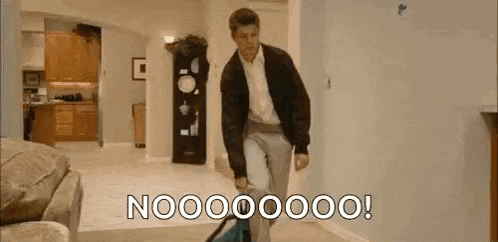 a man is using a vacuum cleaner in a living room .