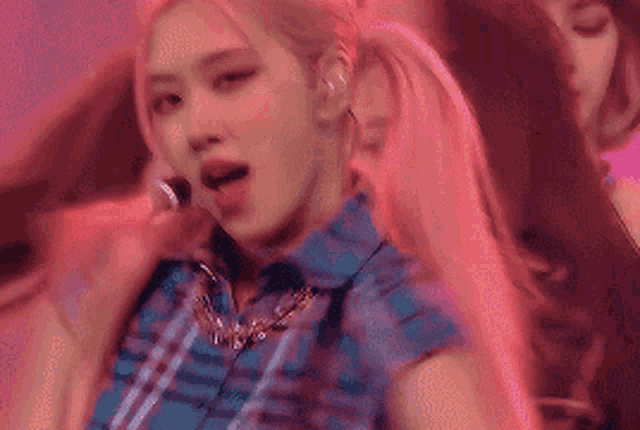 a close up of a woman singing into a microphone .