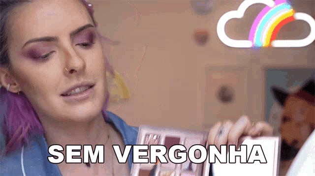 a woman with purple hair is holding a box with sem vergonha on it
