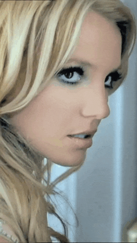 a close up of a woman 's face with blonde hair and blue eyes