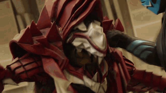 a close up of a person in a red costume with sharp teeth