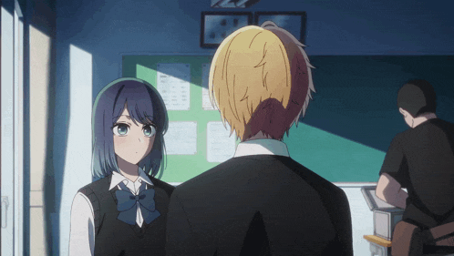 a boy and a girl are looking at each other in front of a bulletin board