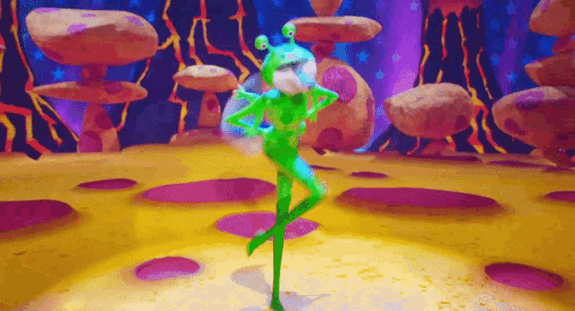 a green alien is dancing on a stage