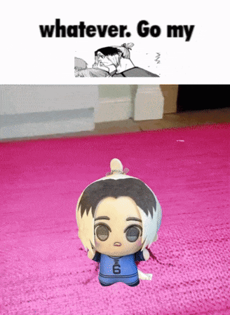a stuffed doll with the number 6 on it is on a pink rug