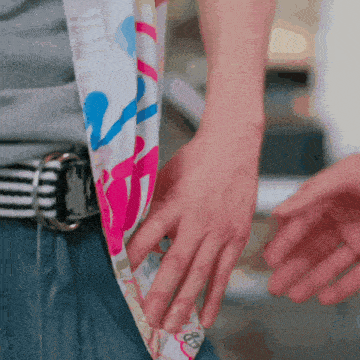 a person wearing a belt and a scarf with a butterfly on it