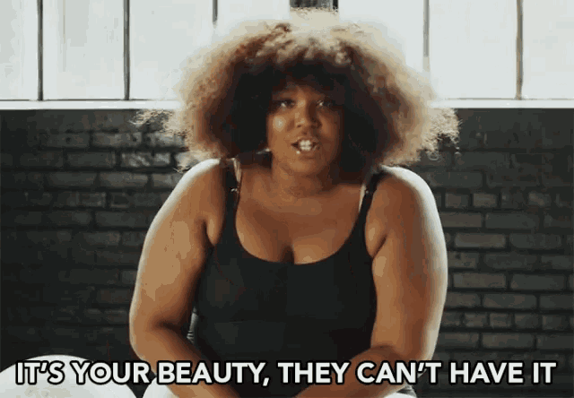 a woman with a big afro says it 's your beauty they can 't have it