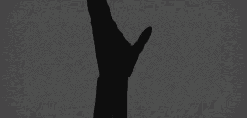 a black and white photo of a hand giving a thumbs up with the word ayudame in white letters behind it