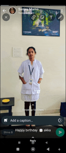 a woman in a lab coat is standing in front of a wall with a picture of a forest on it