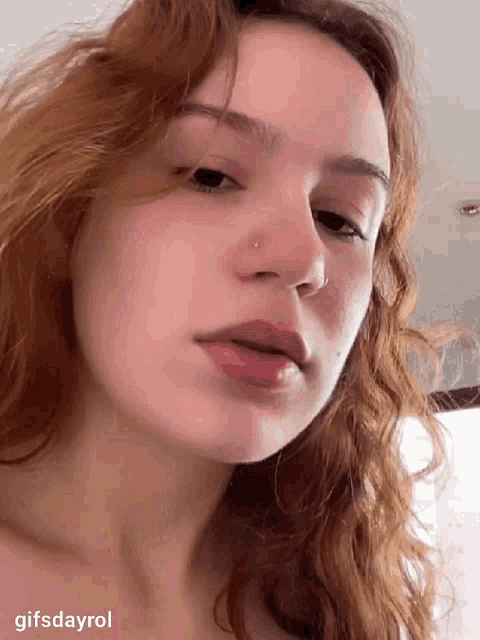 a close up of a woman 's face with a gifsdayrol watermark